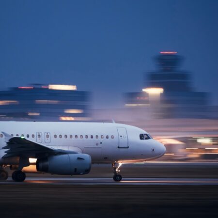 Airplane,During,Take,Off,On,Airport,Runway,At,Night,Against